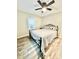 Bedroom with black metal frame bed, ceiling fan, and wood-look flooring at 287 Ben Eller Ln, Taylorsville, NC 28681