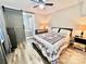 Comfortable bedroom with a decorative quilt, unique sliding barn door and modern lighting, providing a cozy retreat at 287 Ben Eller Ln, Taylorsville, NC 28681