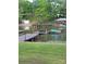 Picturesque dock featuring a covered boat slip and swimming platform on a serene lake setting at 287 Ben Eller Ln, Taylorsville, NC 28681