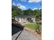 Charming waterfront cottage with a black metal roof, siding, and a well-kept yard at 287 Ben Eller Ln, Taylorsville, NC 28681