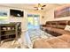 Inviting living room featuring a brown leather sofa, a ceiling fan, and sliding glass doors to the outside at 287 Ben Eller Ln, Taylorsville, NC 28681