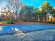 A tranquil street surrounded by lush trees, bathed in sunlight, offering serene neighborhood charm and natural beauty at 287 Ben Eller Ln, Taylorsville, NC 28681