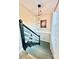 Stylish staircase featuring painted risers, modern lighting fixtures, and a bright window, enhancing the home's interior design at 287 Ben Eller Ln, Taylorsville, NC 28681