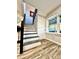 Stairway with a dark railing, a side window, and attractive wood-look flooring at 287 Ben Eller Ln, Taylorsville, NC 28681