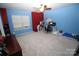 Bedroom with blue and red walls, carpeted floors, and a workspace at 628 Barcroft Ln, Fort Mill, SC 29715