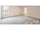 Bedroom featuring neutral carpet, a window that provides ample natural light, and an ensuite bathroom at 110 Dorian Pl, Troutman, NC 28166