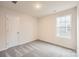 Cozy bedroom featuring neutral carpet, a window that provides ample natural light, and a closet at 110 Dorian Pl, Troutman, NC 28166