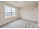 Bright bedroom with a large window, neutral walls and carpet, and a spacious closet at 110 Dorian Pl, Troutman, NC 28166