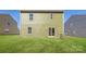 Expansive backyard with a well-maintained lawn and a sliding glass door leading to the house at 112 Dorian Pl, Troutman, NC 28166