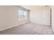Neutral carpeted bedroom with large window. A bright and inviting space at 112 Dorian Pl, Troutman, NC 28166