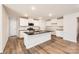 Bright kitchen featuring white cabinets, granite countertops, and stainless steel appliances, offering a modern and stylish cooking space at 112 Dorian Pl, Troutman, NC 28166