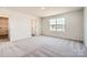 Bedroom with carpet, a window, and access to a walk-in closet at 123 Dorian Pl, Troutman, NC 28166