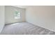 Bedroom featuring carpet flooring and a window for natural light at 123 Dorian Pl, Troutman, NC 28166