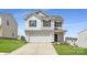 Charming two-story home featuring a two-car garage, gray siding, and a well-manicured lawn at 123 Dorian Pl, Troutman, NC 28166