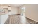 Bright kitchen and dining area featuring hardwood floors and access to the backyard through sliding glass doors at 123 Dorian Pl, Troutman, NC 28166