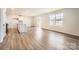 Bright living room showcasing hardwood floors and access to the backyard through sliding glass doors at 123 Dorian Pl, Troutman, NC 28166