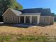 Rear view featuring a covered porch with white columns and light tan siding at 1117 Shadowmoss Ct, Salisbury, NC 28147