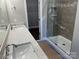 Bathroom featuring double sinks, a large glass shower, and a view into a walk-in closet at 1117 Shadowmoss Ct, Salisbury, NC 28147