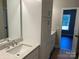 Bright bathroom with a large mirror, white cabinets, and a speckled countertop above the sink at 1117 Shadowmoss Ct, Salisbury, NC 28147