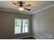 Bright room featuring a fan and large window overlooking the porch at 1117 Shadowmoss Ct, Salisbury, NC 28147
