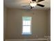 Cozy bedroom featuring a ceiling fan and a window overlooking a serene outdoor view at 1117 Shadowmoss Ct, Salisbury, NC 28147