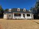 Beautiful home with a brick facade, covered front porch with white columns, and dormer windows at 1117 Shadowmoss Ct, Salisbury, NC 28147
