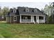 Charming brick home featuring a covered front porch with white columns and a well-maintained lawn at 1117 Shadowmoss Ct, Salisbury, NC 28147