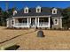 Attractive brick home featuring a covered front porch, dormer windows, and manicured landscaping at 1117 Shadowmoss Ct, Salisbury, NC 28147