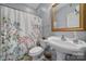 Cozy bathroom featuring floral shower curtain, white fixtures, and gold-framed mirror at 1567 Fayrene Rd, Rock Hill, SC 29732