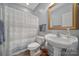Clean bathroom with neutral walls, white fixtures, and a striped shower curtain at 1567 Fayrene Rd, Rock Hill, SC 29732