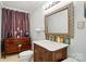 Cozy bathroom with dark wood vanity, decorative mirror and tile accents at 1567 Fayrene Rd, Rock Hill, SC 29732