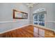 Well-lit dining room with hardwood floors, large window, and decorative mirror with elegant trim at 1567 Fayrene Rd, Rock Hill, SC 29732