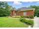 Charming brick home with manicured lawn, stone detail, covered entryway, and mature greenery at 1567 Fayrene Rd, Rock Hill, SC 29732