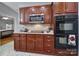 Well-equipped kitchen with dark wood cabinets, stainless steel microwave, and built-in double ovens at 1567 Fayrene Rd, Rock Hill, SC 29732