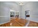 Open-concept living area with hardwood floors, large windows, and high ceilings with chandelier at 1567 Fayrene Rd, Rock Hill, SC 29732