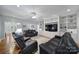 Bright living area featuring built-in shelving, black leather sofas, and hardwood flooring throughout at 1567 Fayrene Rd, Rock Hill, SC 29732