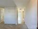 Bright hallway with carpet and tiled floors leading to a sunlit room at 1239 Jordans Pond Ln, Charlotte, NC 28214