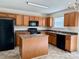 Spacious kitchen featuring an island, modern appliances and wooden cabinets at 1239 Jordans Pond Ln, Charlotte, NC 28214