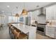 Modern kitchen with white cabinets, stainless steel appliances, and large island at 1925 Dunavant St, Charlotte, NC 28203