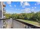 A view from a balcony overlooking a grassy field with trees and parked cars at 211 Heritage Blvd # 502, Fort Mill, SC 29715