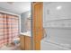 This bathroom features a vanity and cabinet, toilet, shower with curtain, and a stacked washer and dryer unit at 211 Heritage Blvd # 502, Fort Mill, SC 29715