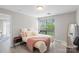 Comfortable bedroom with a cozy bed, bedside table, and a large window offering lots of natural light at 211 Heritage Blvd # 502, Fort Mill, SC 29715