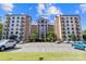 A condominium building with balconies and a parking lot under a sunny blue sky at 211 Heritage Blvd # 502, Fort Mill, SC 29715