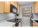 Eat-in kitchen with a stove top, microwave, ample counter space, and modern appliances at 211 Heritage Blvd # 502, Fort Mill, SC 29715