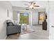Living room with laminate wood flooring, ceiling fan, and sliding glass doors to balcony at 211 Heritage Blvd # 502, Fort Mill, SC 29715