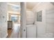 Stackable washer and dryer in a well-lit laundry room with extra shelving at 115 E Park Ave # 419, Charlotte, NC 28203