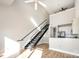 Open living area with loft, modern staircase, and hardwood floors at 115 E Park Ave # 419, Charlotte, NC 28203