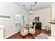 Cozy breakfast nook with glass table and four chairs at 19556 Makayla Ln, Cornelius, NC 28031