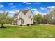 Backyard view showcasing a refreshing swimming pool and a spacious, green lawn at 500 Pearl Place Ln, York, SC 29745