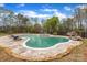 A spacious backyard features a large gunite pool with a rock feature and integrated hot tub, surrounded by mature trees at 500 Pearl Place Ln, York, SC 29745